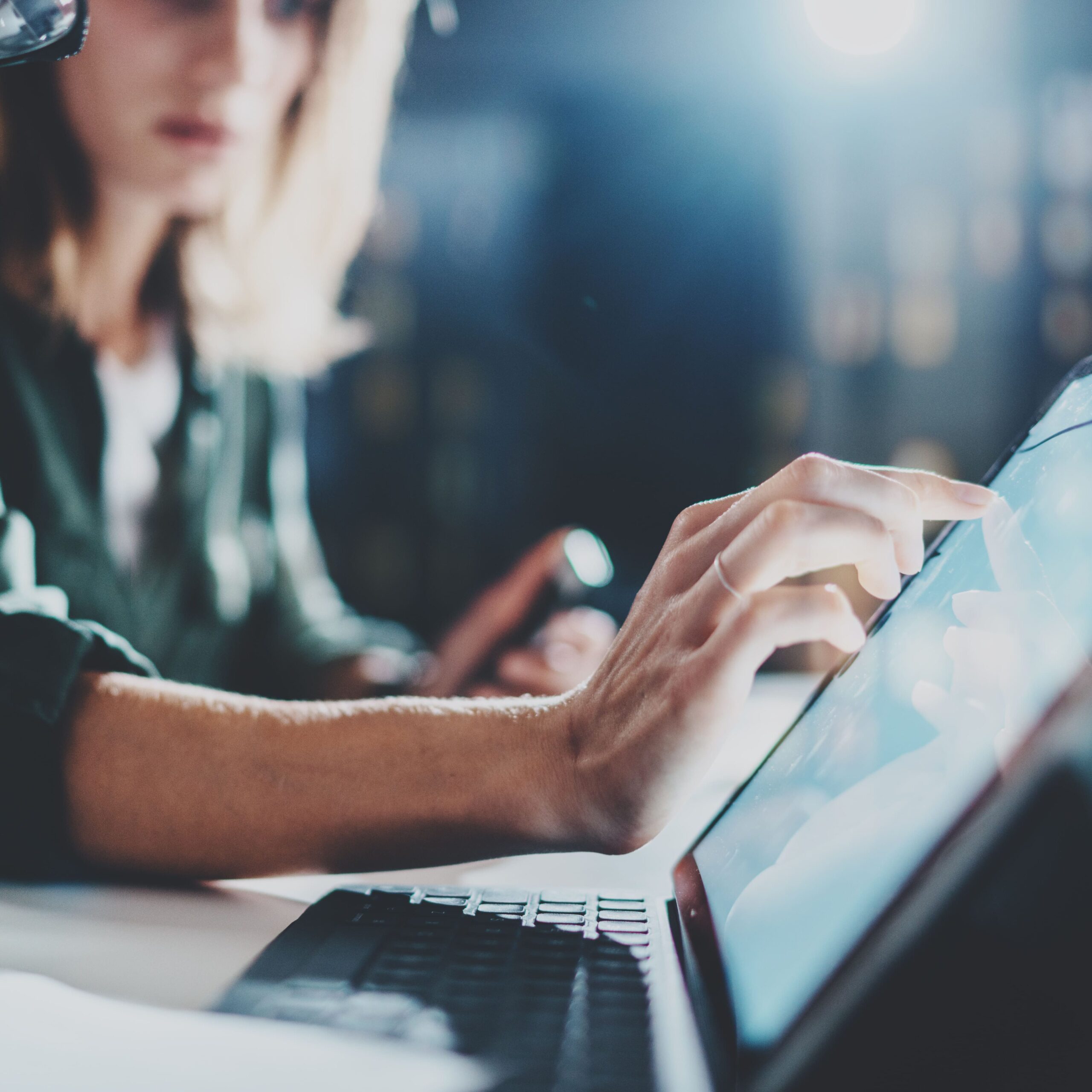 Businessman With Laptop In Network Server Room A woman pointing on digital tablet screen.